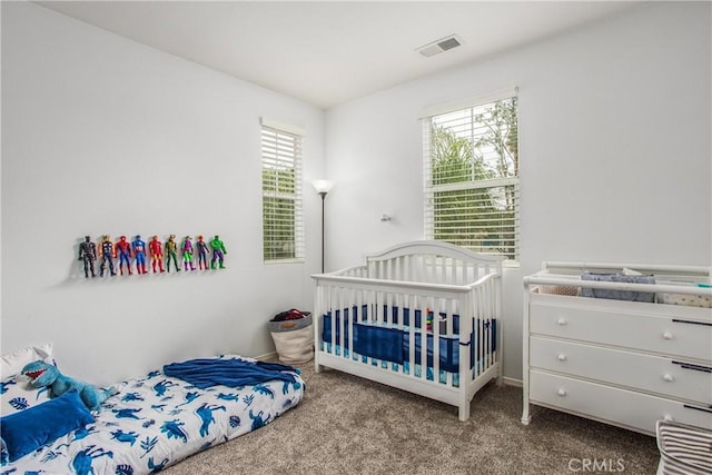 carpeted bedroom with baseboards and visible vents