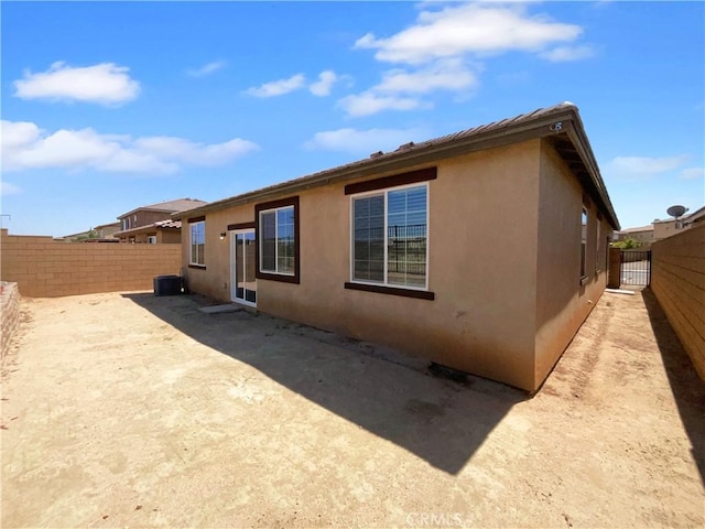 view of property exterior featuring a fenced backyard, stucco siding, and cooling unit