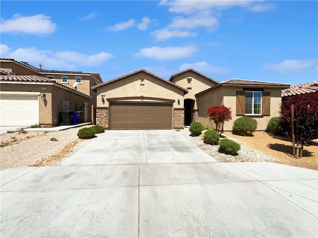 view of front facade with a garage, stucco siding, and concrete driveway