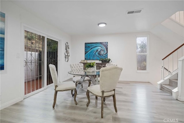 dining space featuring visible vents, plenty of natural light, and light wood-style flooring