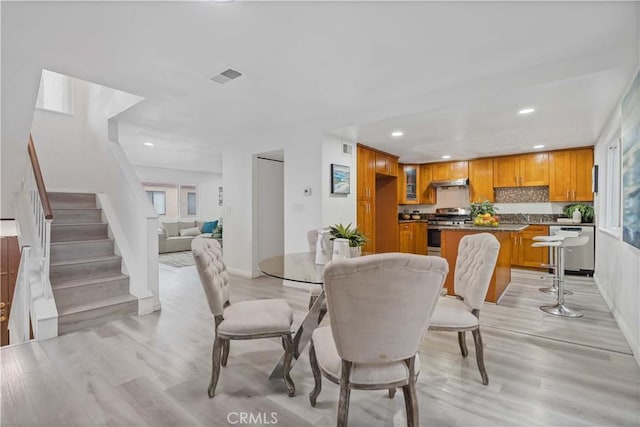 dining area featuring recessed lighting, visible vents, stairway, and light wood-type flooring