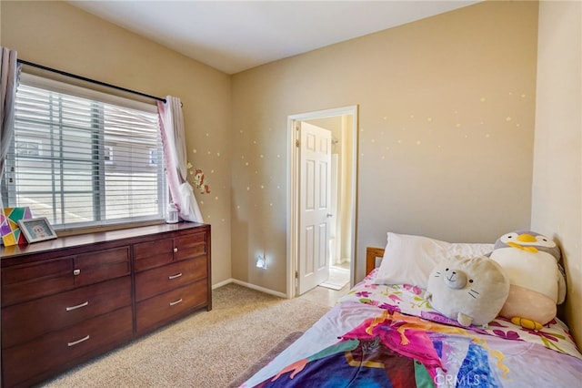 bedroom featuring light carpet and baseboards
