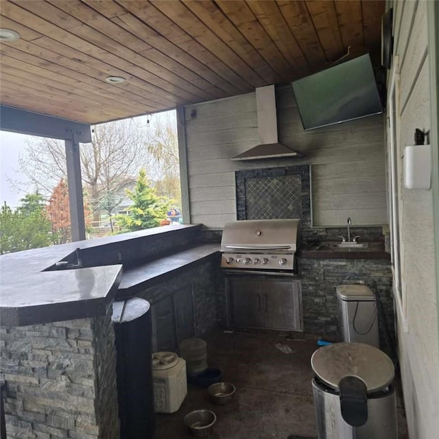 view of patio / terrace featuring exterior kitchen, a sink, outdoor wet bar, and a grill