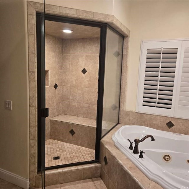 bathroom featuring a stall shower and a jetted tub