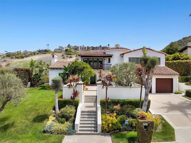 2839 Via Victoria, Palos Verdes Estates, CA 90274 - mediterranean / spanish-style house featuring a tile roof, stairway, stucco siding, concrete driveway, and a front lawn