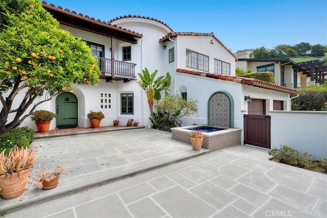 2839 Via Victoria, Palos Verdes Estates, CA 90274 - view of front of property featuring stucco siding, a balcony, a gate, a patio area, and a tiled roof
