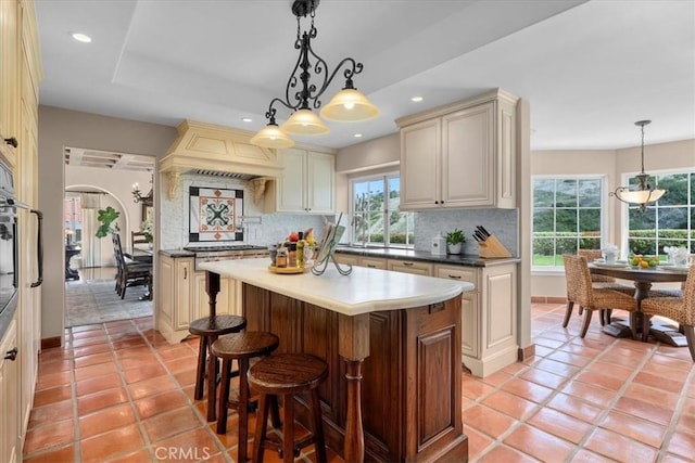 2839 Via Victoria, Palos Verdes Estates, CA 90274 - kitchen featuring cream cabinets, backsplash, a kitchen island, arched walkways, and recessed lighting
