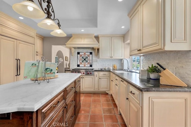 2839 Via Victoria, Palos Verdes Estates, CA 90274 - kitchen with cream cabinetry, a sink, custom range hood, stainless steel gas stovetop, and tasteful backsplash