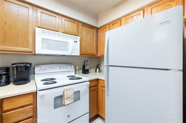 kitchen featuring light countertops and white appliances