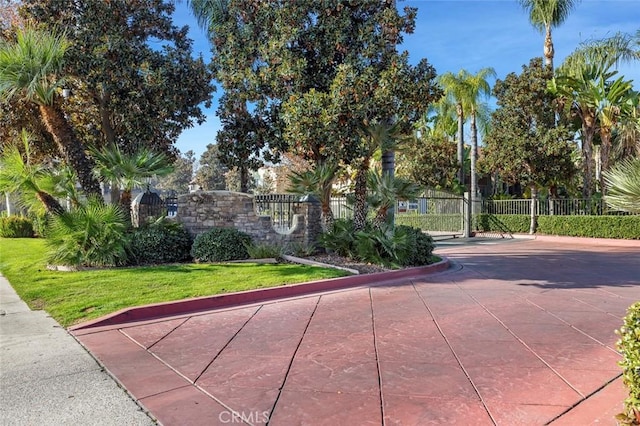 surrounding community featuring a lawn, a gate, and fence