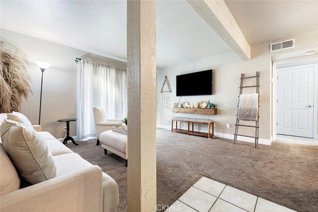 living room with a textured ceiling, visible vents, and carpet