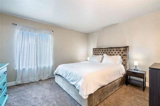 bedroom with baseboards and carpet floors