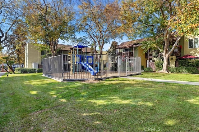 exterior space with fence and a lawn