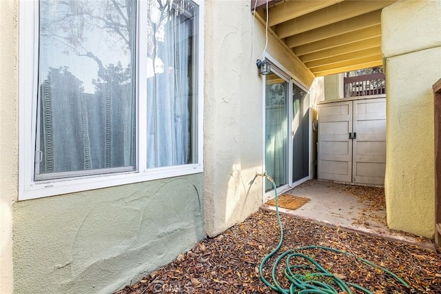 view of side of property with stucco siding