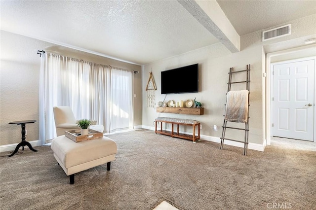 carpeted living area with a textured ceiling, visible vents, beam ceiling, and baseboards