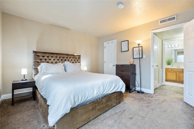 bedroom featuring visible vents, baseboards, and light carpet