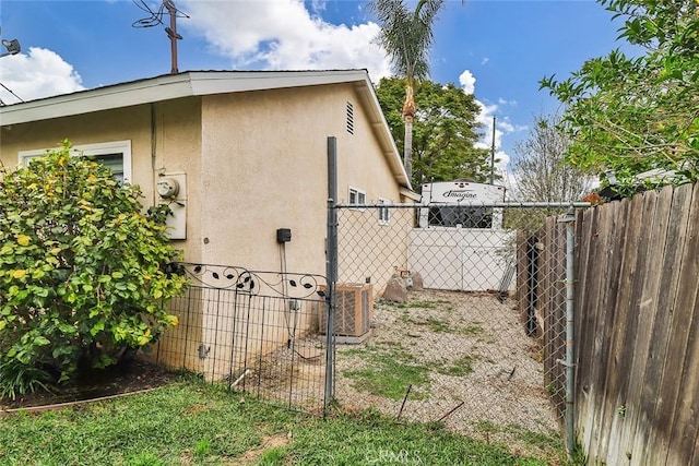 view of property exterior featuring fence, stucco siding, and cooling unit