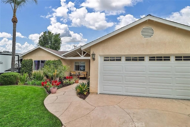 ranch-style home featuring a front lawn, stucco siding, concrete driveway, and an attached garage