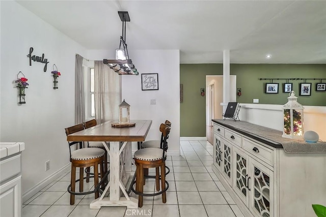 dining space with light tile patterned floors, recessed lighting, and baseboards