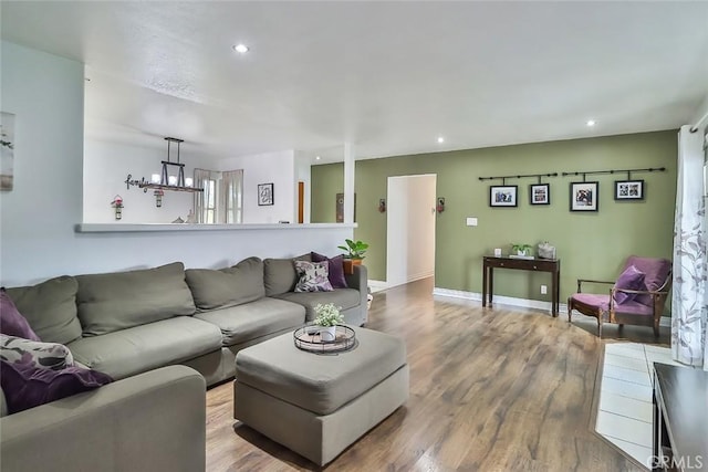 living room featuring baseboards, recessed lighting, and wood finished floors