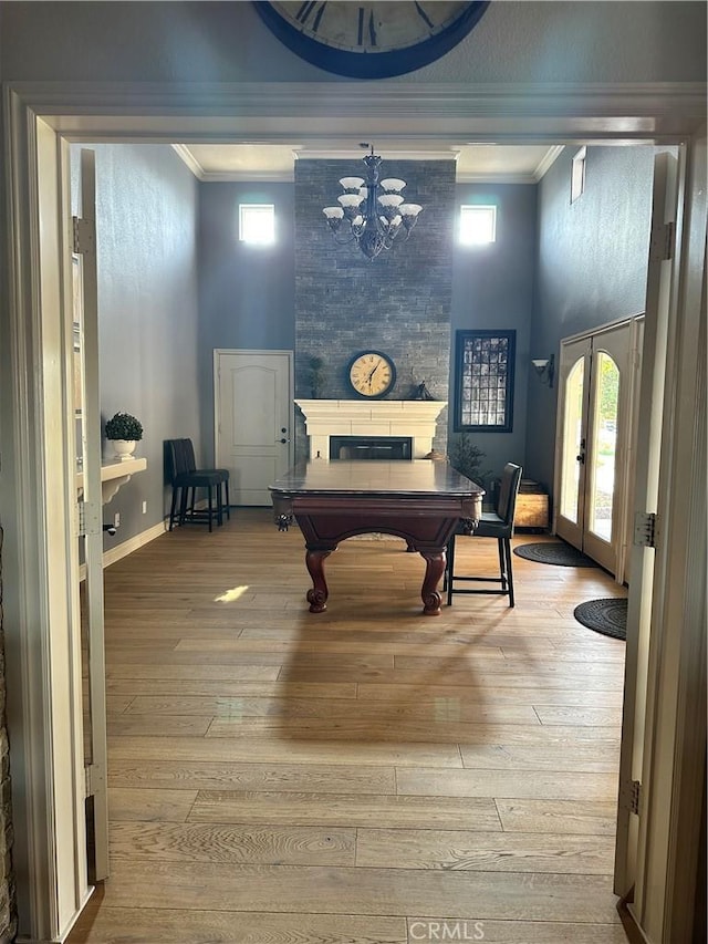 recreation room with french doors, crown molding, baseboards, and wood-type flooring