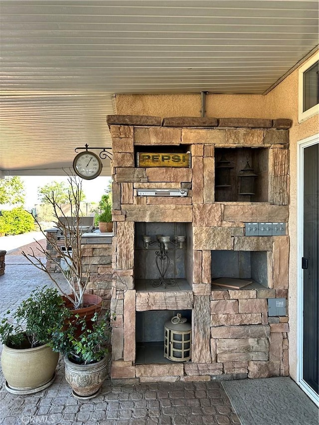 exterior details with a stone fireplace