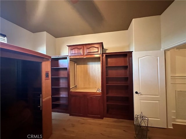 spacious closet featuring visible vents and wood finished floors