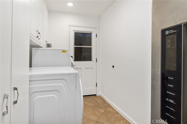 laundry area featuring light tile patterned floors, washing machine and clothes dryer, baseboards, recessed lighting, and cabinet space