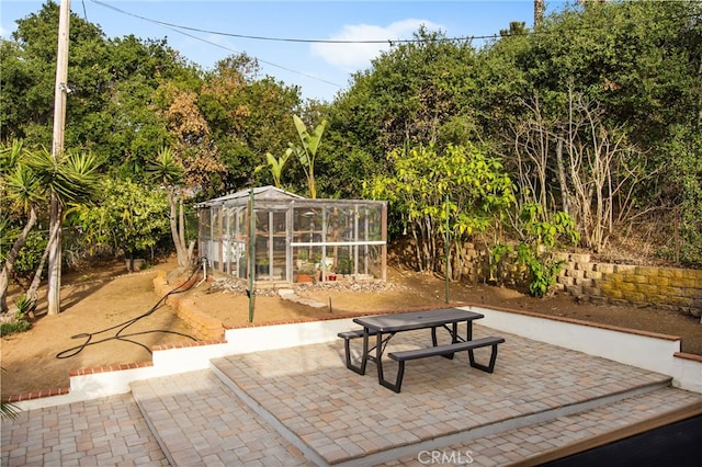 view of patio / terrace with an outbuilding, outdoor dining area, and an exterior structure