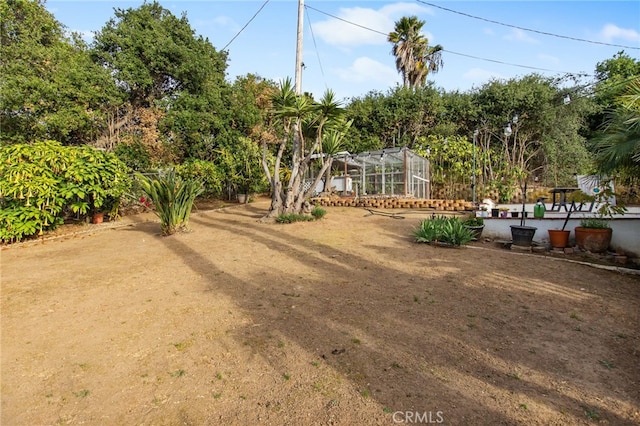 view of yard with glass enclosure
