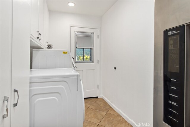 laundry room with recessed lighting, cabinet space, washer and clothes dryer, light tile patterned floors, and baseboards