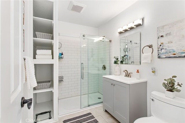 full bathroom featuring a shower stall, vanity, toilet, visible vents, and tile patterned flooring