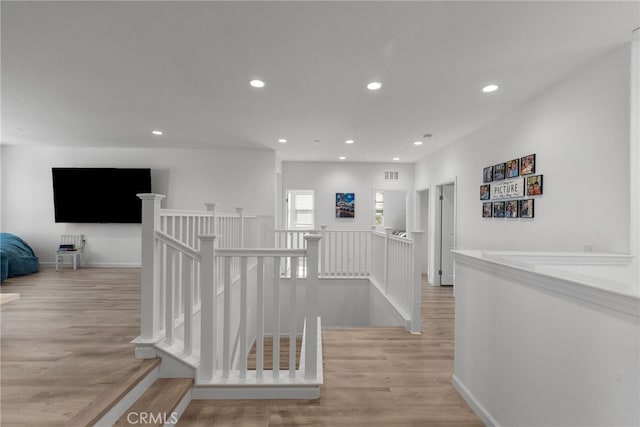 18797 Big Cedar Dr, Canyon Country, CA 91387 - hallway with light wood-style floors, visible vents, recessed lighting, and an upstairs landing