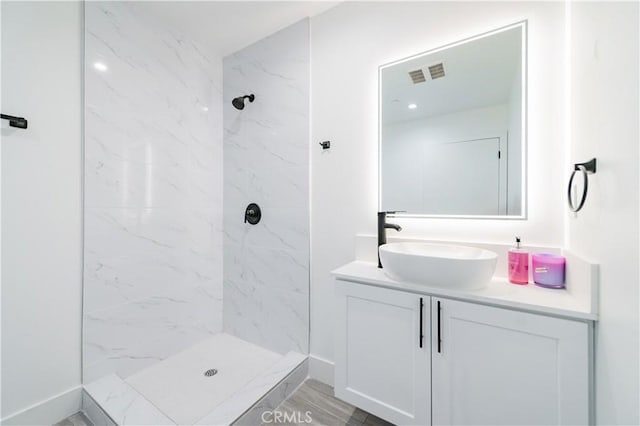 1444 W 37th St, Los Angeles, CA 90018 - bathroom featuring tiled shower, vanity, and visible vents