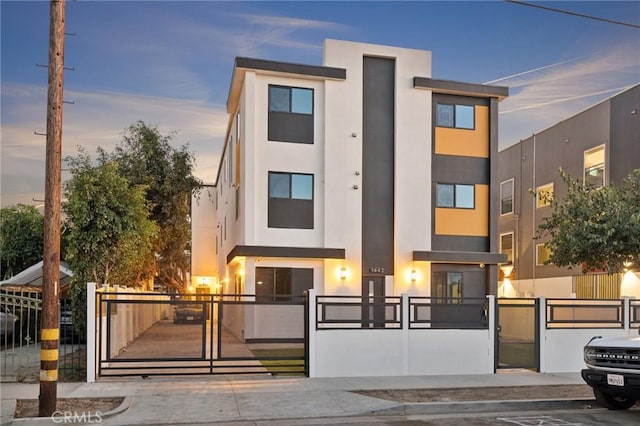 1444 W 37th St, Los Angeles, CA 90018 - view of front of property with a gate, stucco siding, and a fenced front yard