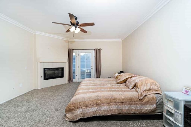 bedroom with crown molding, ceiling fan, carpet floors, a fireplace, and access to outside