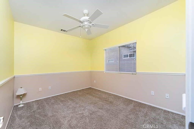 unfurnished room featuring a ceiling fan, visible vents, carpet, and baseboards