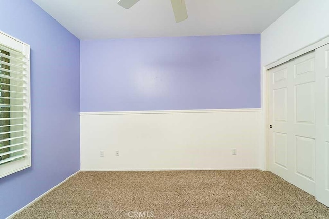 unfurnished bedroom with a ceiling fan and carpet floors