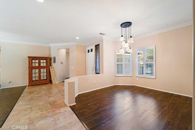 interior space featuring wood finished floors, crown molding, and baseboards
