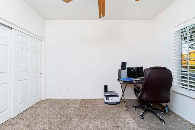carpeted home office featuring a ceiling fan