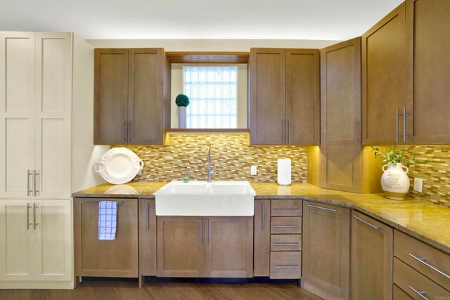 1710 Via Allondra, San Marcos, CA 92078 - kitchen with brown cabinets, light stone counters, a sink, and tasteful backsplash