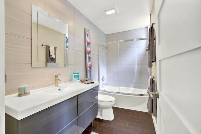 1710 Via Allondra, San Marcos, CA 92078 - bathroom featuring vanity, shower / bath combination with glass door, toilet, wood tiled floor, and tasteful backsplash