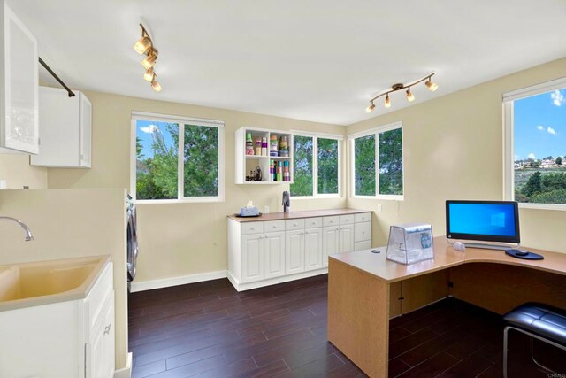1710 Via Allondra, San Marcos, CA 92078 - home office featuring a sink, baseboards, dark wood-style flooring, and rail lighting