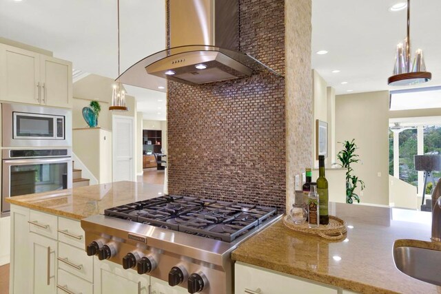 1710 Via Allondra, San Marcos, CA 92078 - kitchen with light stone countertops, wall chimney exhaust hood, stainless steel appliances, decorative light fixtures, and decorative backsplash