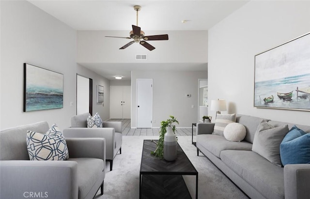 living area with visible vents, ceiling fan, and high vaulted ceiling