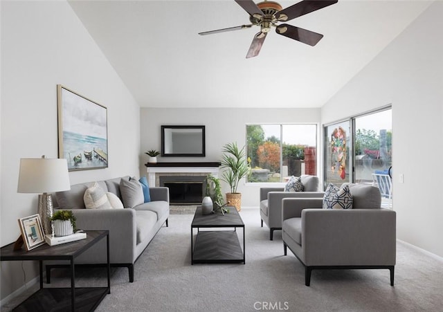 carpeted living room featuring baseboards, a ceiling fan, vaulted ceiling, and a fireplace