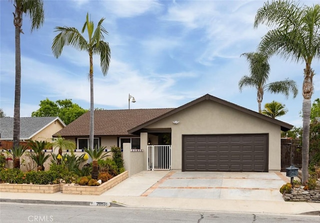 single story home with a shingled roof, an attached garage, stucco siding, concrete driveway, and fence private yard