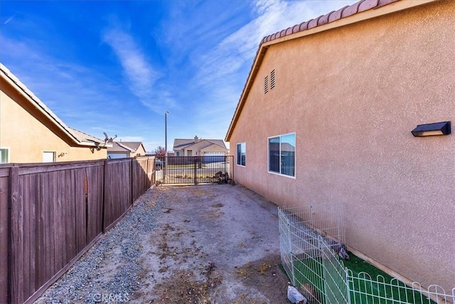 view of property exterior with stucco siding and fence
