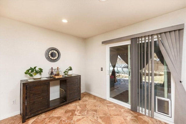 doorway featuring recessed lighting and baseboards