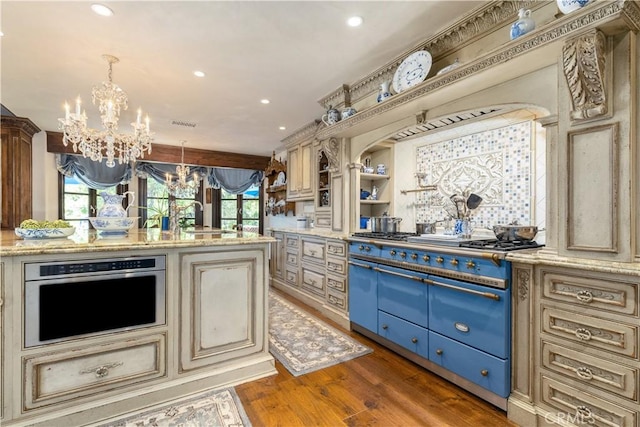 1015 Wild Oats Way, Templeton, CA 93465 - kitchen featuring wood finished floors, light stone counters, a chandelier, oven, and cream cabinetry